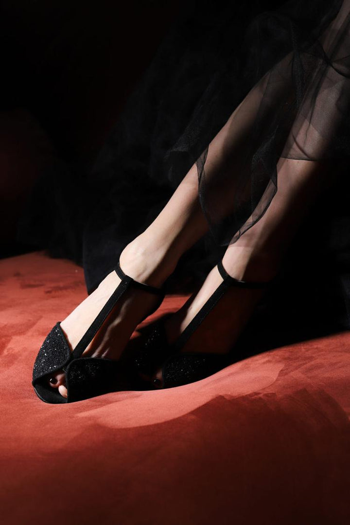 Black sandals with open toe and sparkling T-strap buckle